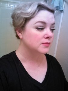 I put on my makeup, paying attention to the eyebrows because 20s eyebrows were darker and rounder than what we're used to wearing today.