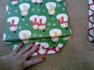 Then, press one edge down over the side of the item/package, rubbing seams in so that there is a snug fit.