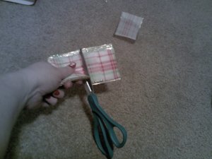 Use your scissor to make slits on either side of the ribbon.