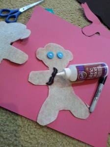 Making a pattern for, then cutting out, then gluing on his mustache.