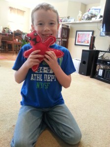 And with his finished product, he had learned to make a pattern, cut fabric, sew buttons, stitch a seam, and stuff a bear.  Next up, we're making a green bear with a blanket stitch.